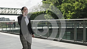 Happy Woman in Formal Clothes Talking on the Mobile Phone, Giving Advices for Office Members. Business Lady Going to the