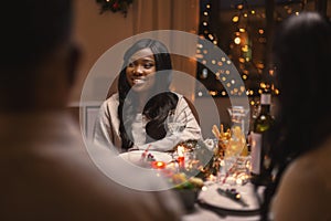 happy woman with friends having christmas dinner