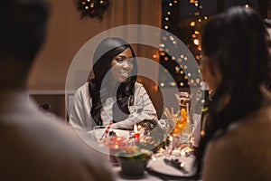 happy woman with friends having christmas dinner