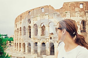 Happy woman in front of colosseum in rome, Italy