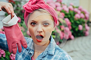 Happy woman gardener with flowers. woman care of flowers in garden. Flower care and watering. soils and fertilizers