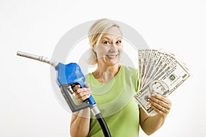 Happy woman with gas pump and money.