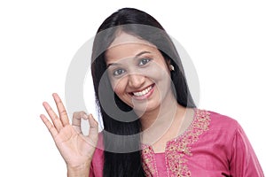 Happy woman gesturing OK sign