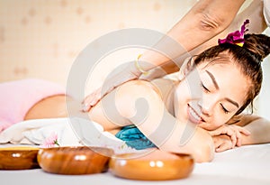 Happy Woman is getting her back scrub in Thai Spa treatment