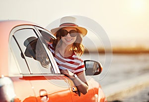 Happy woman girl goes to summer travel trip in   car