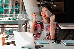 Happy woman girl teenager raising hands with gladness happiness