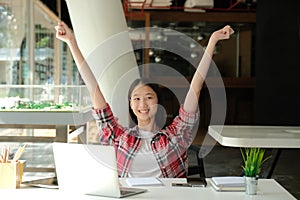 Happy woman girl teenager raising hands with gladness happiness