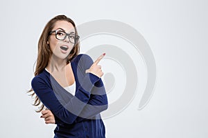 Happy woman in glasses pointing finger away