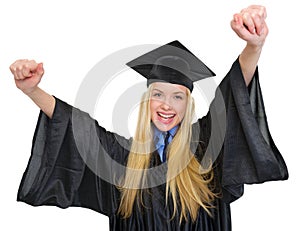 Happy woman in graduation gown rejoicing success