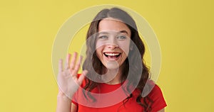 Happy woman greeting by waving hand