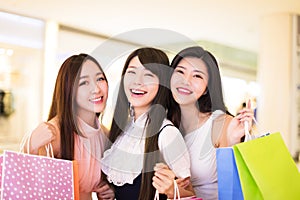 Happy woman group holding shopping bags