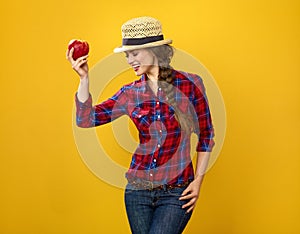 Happy woman grower isolated on yellow posing with an apple