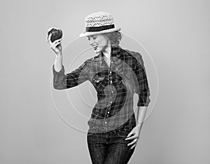 Happy woman grower isolated on yellow posing with an apple