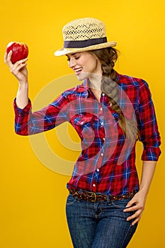 Happy woman grower isolated on yellow posing with an apple