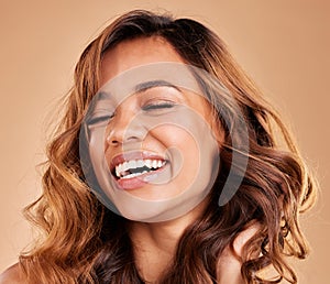 Happy woman, hair care and face with beauty, laughing and cosmetics and balayage on studio background. Skincare, keratin