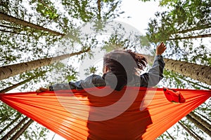 happy woman on hammock in the forest
