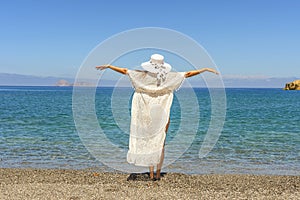 Happy woman in a hat on a tropical beach. Summer vacation concept