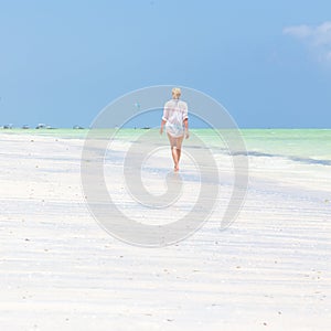 Happy woman having fun, enjoying summer, running along white tropical beach.