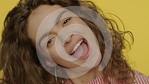 Happy woman having fun with lemon halves in studio. Fashion model face smiling