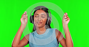 Happy woman, headphones and dance to music on green screen against a studio background. Portrait of female person smile