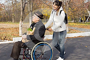 Happy woman helping a disabled elderly man