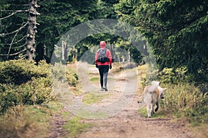 Happy woman hiking walking with dog