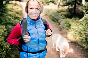 Happy woman hiking walking with dog