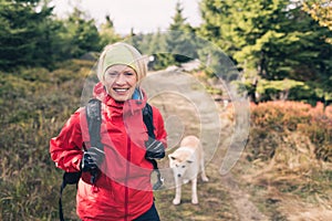 Happy woman hiking walking with dog