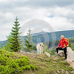 Happy woman hiking walking with dog in mountains, Poland