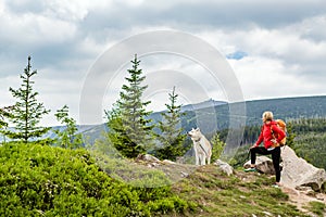 Happy woman hiking walking with dog in mountains, Poland