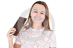 Happy woman holding bar chocolate looks in camera