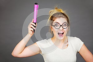 Happy woman holding big oversized pencil