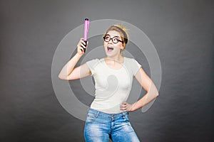 Happy woman holding big oversized pencil