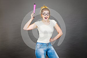 Happy woman holding big oversized pencil