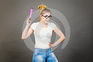 Happy woman holding big oversized pencil