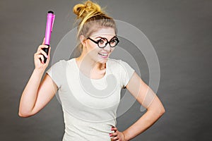 Happy woman holding big oversized pencil