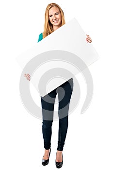 Happy woman holding a blank white board