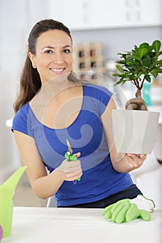 happy woman holding bonsai