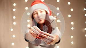 Happy woman holding burning sparklers in New Year holiday.