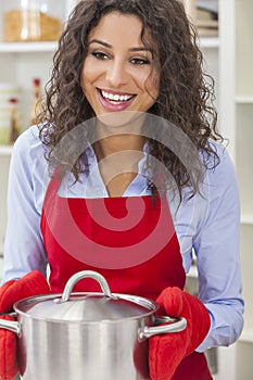 Happy Woman Holding Cooking Pot in Kitchen