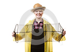 Happy woman holding empty fishing keepnet