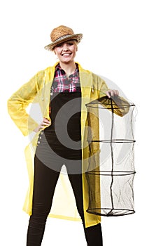 Happy woman holding empty fishing keepnet