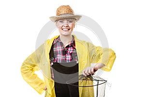 Happy woman holding empty fishing keepnet