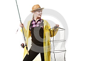 Happy woman holding fishing rod and keepnet