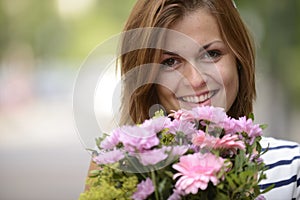 Happy woman holding floral arrangement