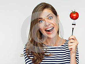 Happy woman holding fork with tomato.