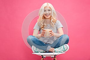 Happy woman holding glass with cappuccino