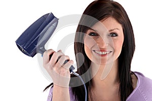 Happy woman holding hairdryer