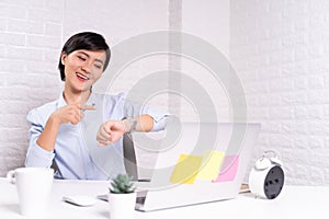 Happy woman holding hand with wrist watch