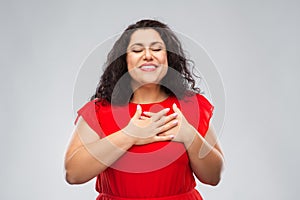 Happy woman holding hands on chest or heart